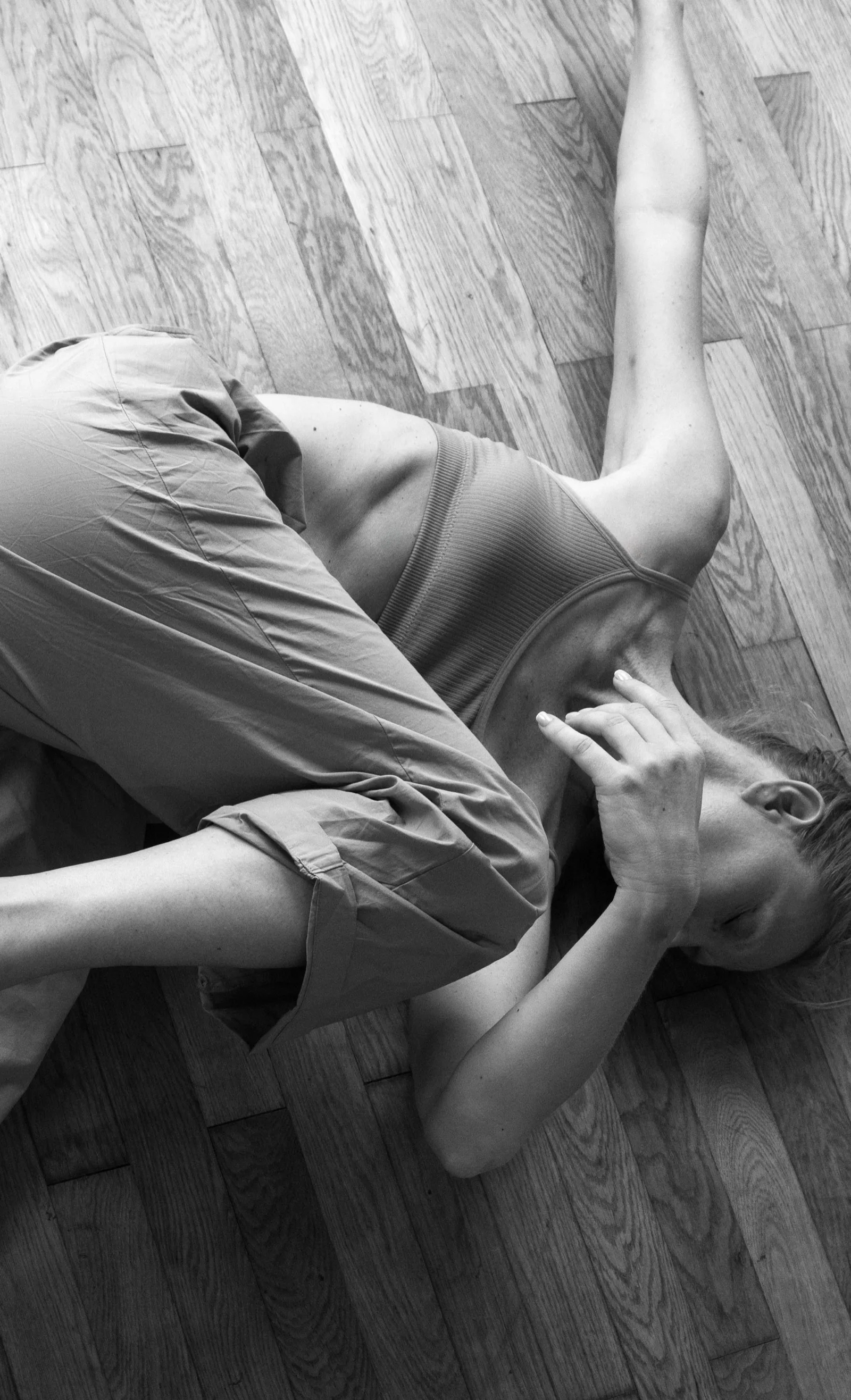 A MUNZ FLOOR® practitioner on the floor, photographed in black and white.